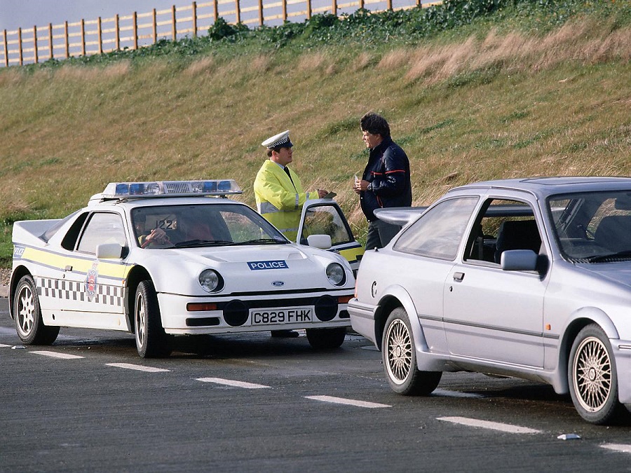 A police officer pulls over a Sierra Cosworth