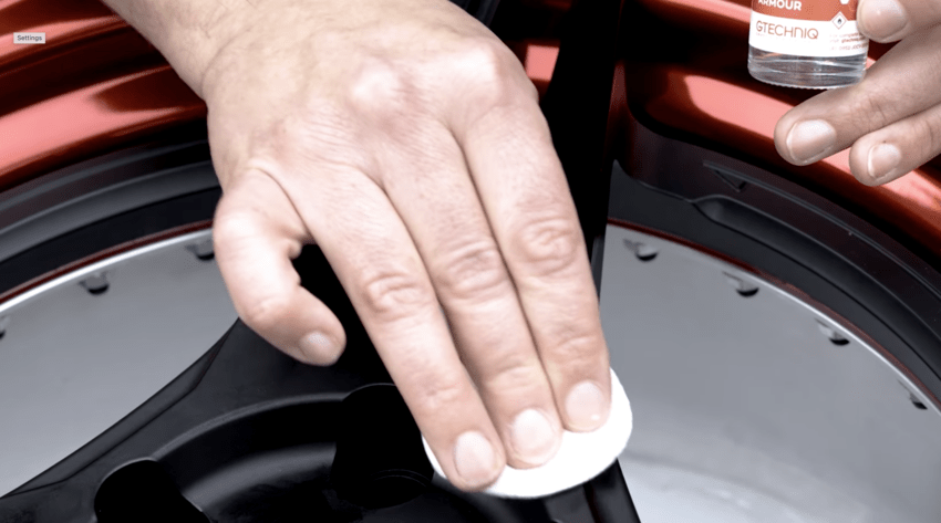 Applying C5 Wheel Protector to a black alloy wheel
