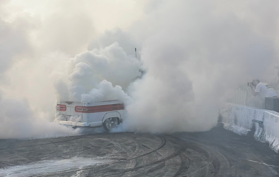 Chevy truck covering Jules and Joe in tire smoke.