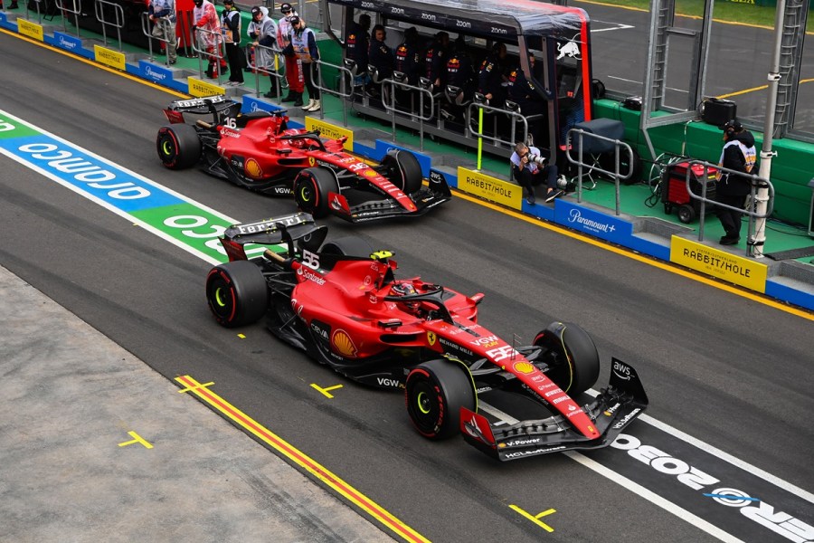2023 Ferrari F1 cars in the pit lane.