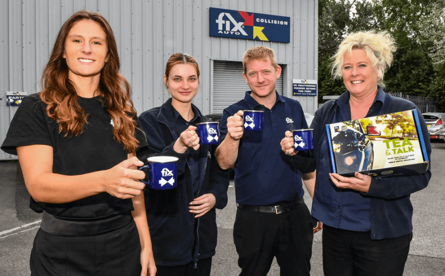 Fix Auto Employers posing with tea mugs after a recent Tea & Talk event