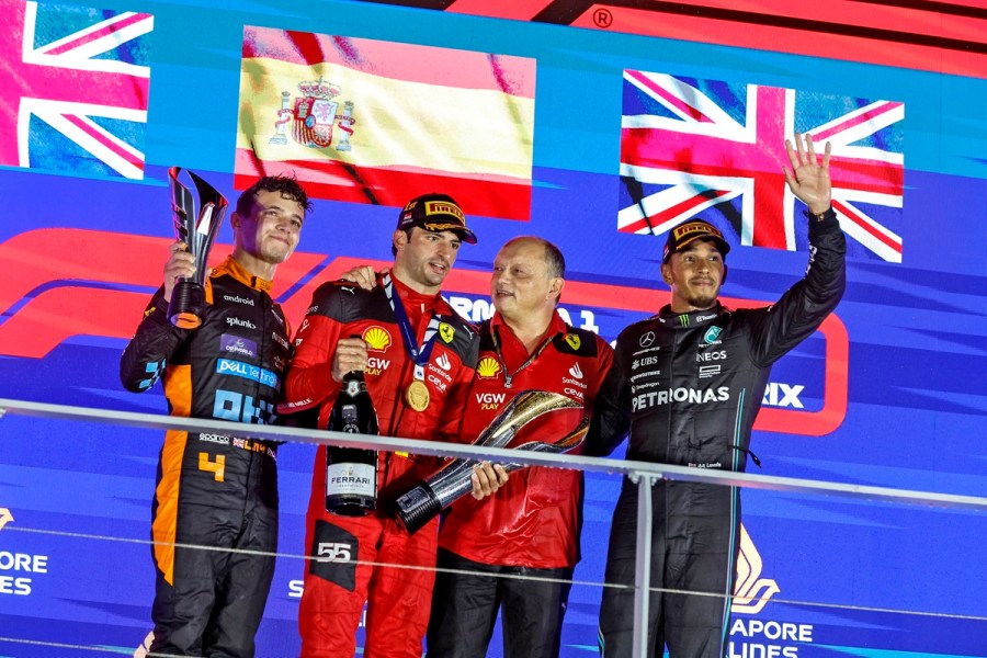 Lewis Hamilton stands on the podium alongside Vasseur, Sainz and Norris