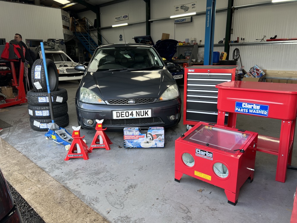 Ford Focus ST170 in workshop surrounded by tools and equipment