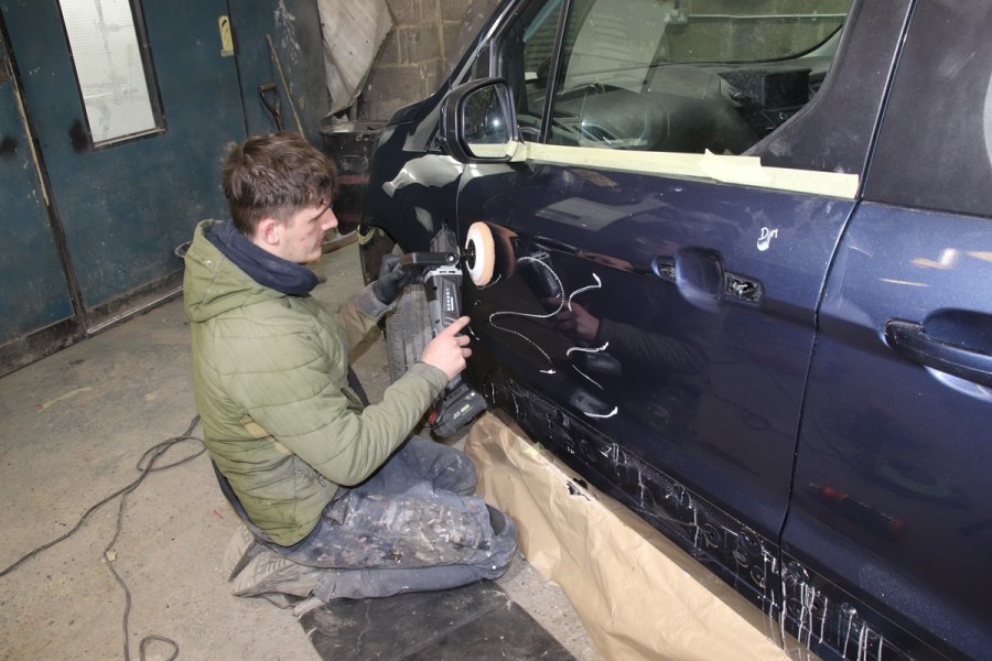 Using the Sealey polisher on a car door.
