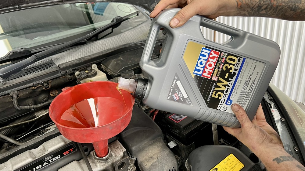 adding engine oil to a Ford engine
