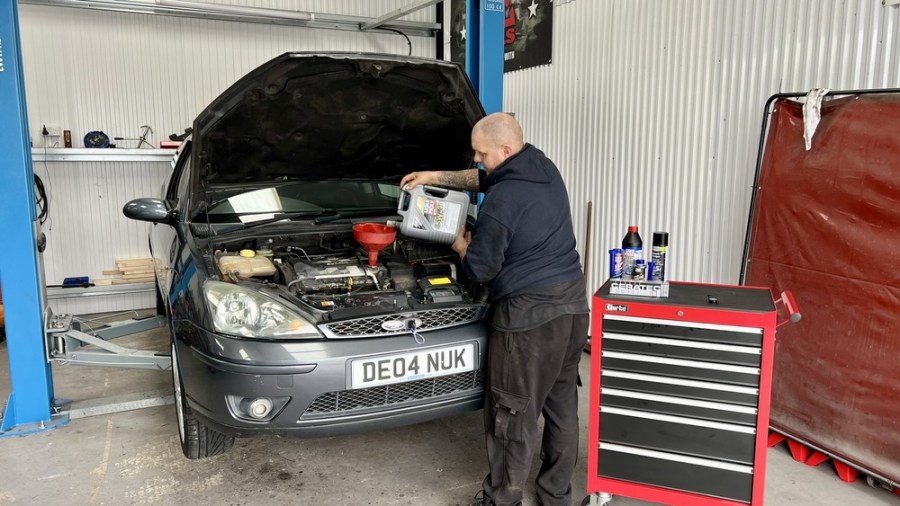 mechanic completing engine service on Ford Focus ST170