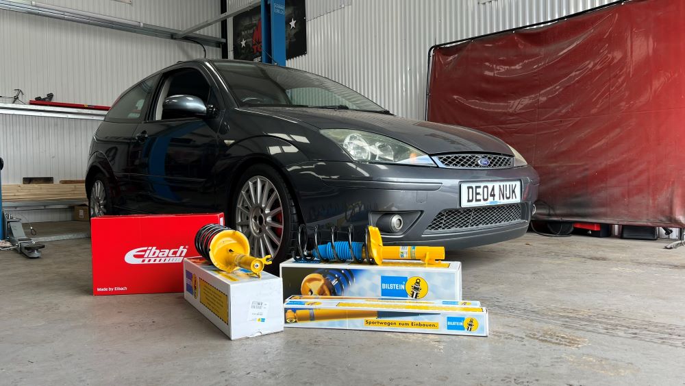 Boxes of Bilstein suspension in front of a Focus ST170