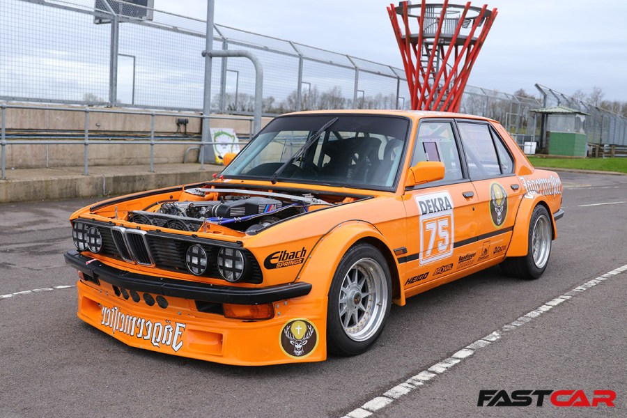 front 3/4 shot of bmw e28 race car with engine exposed