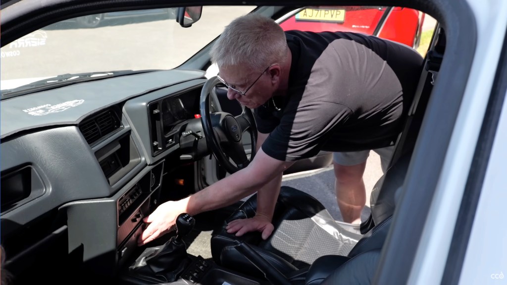 Man shows the orginality of this Ford Sierra Cosworth interior