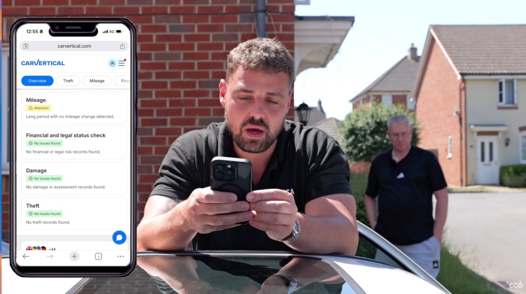 Man completing carVertical check on his phone before buying a Sierra Cosworth