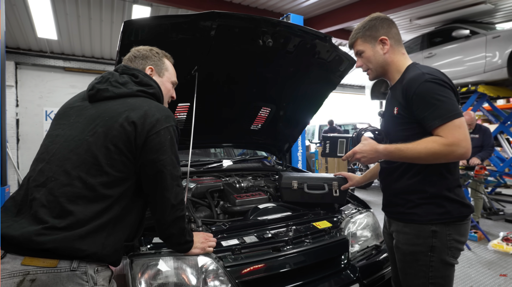 Auto Alex and Taylor discussing faults found when inspecting under the bonnet of a Lotus Carlton