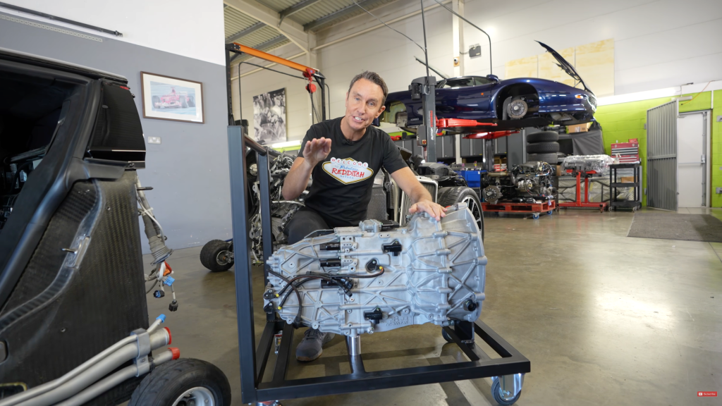 Mark McCann leaning over a rebuilt gearbox for his Bugatti Veyron