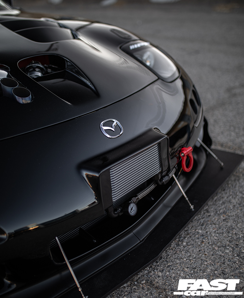 A close up of the front grill of a black Rotor Mazda RX 7
