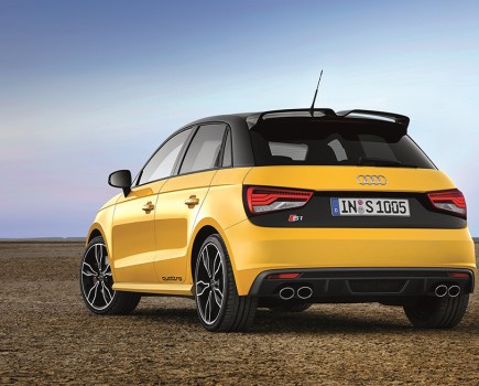 Back left shot of yellow Audi S1 with a desert background
