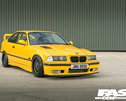 A front right side shot of a black and yellow BW Series 3 E36
