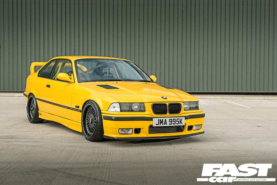 A front right side shot of a black and yellow BW Series 3 E36