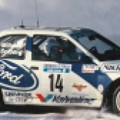 A close up right side door shot of a blue and white Escort Cosworth WRC