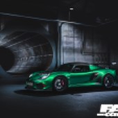 A front left side view of a bright green Lotus Exige Cup 430