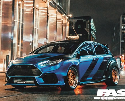 A low front left shot of a black and blue Ford Fiesta ST a night