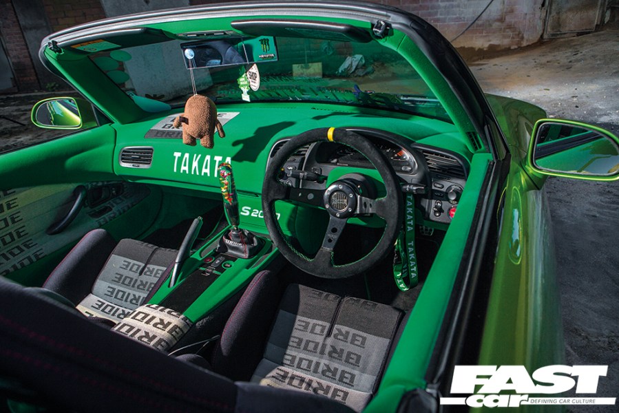 The modified interior of a bright green Honda S2000