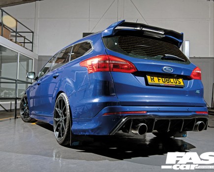 A rear left side view of a bright blue Ford Focus ST
