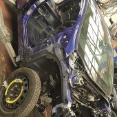 A right side view of a taken apart blue Ford Fiesta
