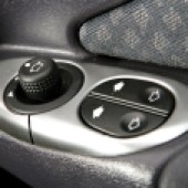A close up of the door and window controls in a Ford Puma