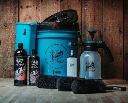 Display of the Auto Finesse products on a wooden table with a wooden wall behind