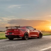 A rear right side driving shot of a red Hennessey Exorcist Camaro ZL