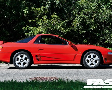 A close up shot of the right side of a red Mitsubishi 3000 GT