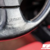 A close up focused shot of the steering wheel inside a Honda Integra Type R