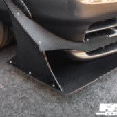 A close up of the front right corner of a grey modified Nissan Skyline R32 GT R