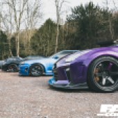 A view across three bonnets of different coloured Nissan GT R