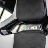 The M3 symbol on the head rest in a BMW M3