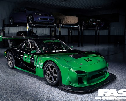 A front right side shot of a green and black Mazda Quad Rotor RX 7