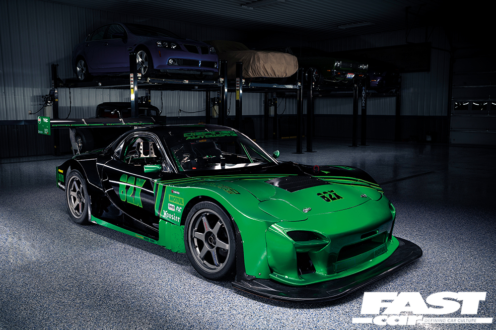 A front right side shot of a green and black Mazda Quad Rotor RX 7
