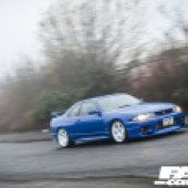 A motion shot of a modified Nissan Skyline GT-R R33