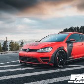 A front left side shot of a black and red Revo VW Golf R