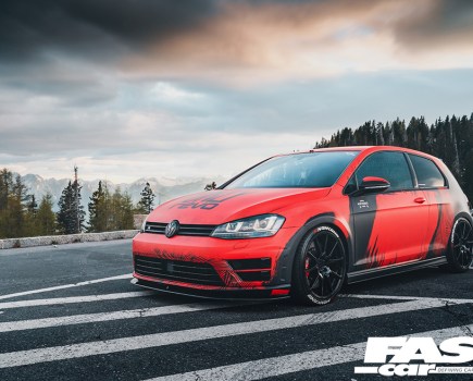 A front left side shot of a black and red Revo VW Golf R