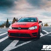 A low frontal shot of a black and red Revo VW Golf R