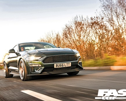 A low front right shot of a green Supercharged Mustang Steeda driving