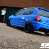 Low rear left side shot of a bright blue Renault Clio Sport 182
