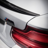 A close up of the rear right light and silver badge of a BMW M2