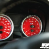 A close up of the red dials in a tuned BMW E92 335i