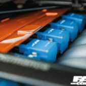 Blue and orange parts of the engine inside a tuned BMW E92 335i